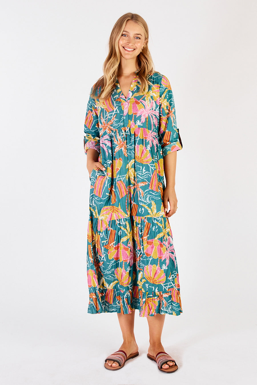 A model wearing the Harlow Midi Dress in colour Sea (Green), from the front, showing the whole outfit