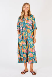 A model wearing the Harlow Midi Dress in colour Sea (Green), from the front, showing the whole outfit