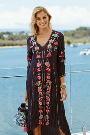 A model wearing the Hayman Dress in colour Navy (Blue), from the front, showing the whole outfit