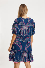 A model wearing the Idalia Cotton Dress in colour Navy (Blue), from the back