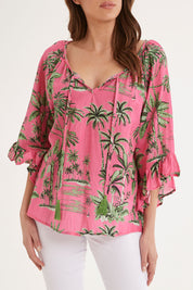 Model Madeline wearing size S of the Island Girl Top in colour Musk (Pink), from the front, cropped image
