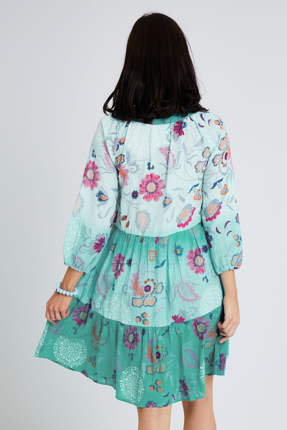 Model Andrea wearing size S of the Jerri Tiered Dress in colour Lagoon (Green), from the back