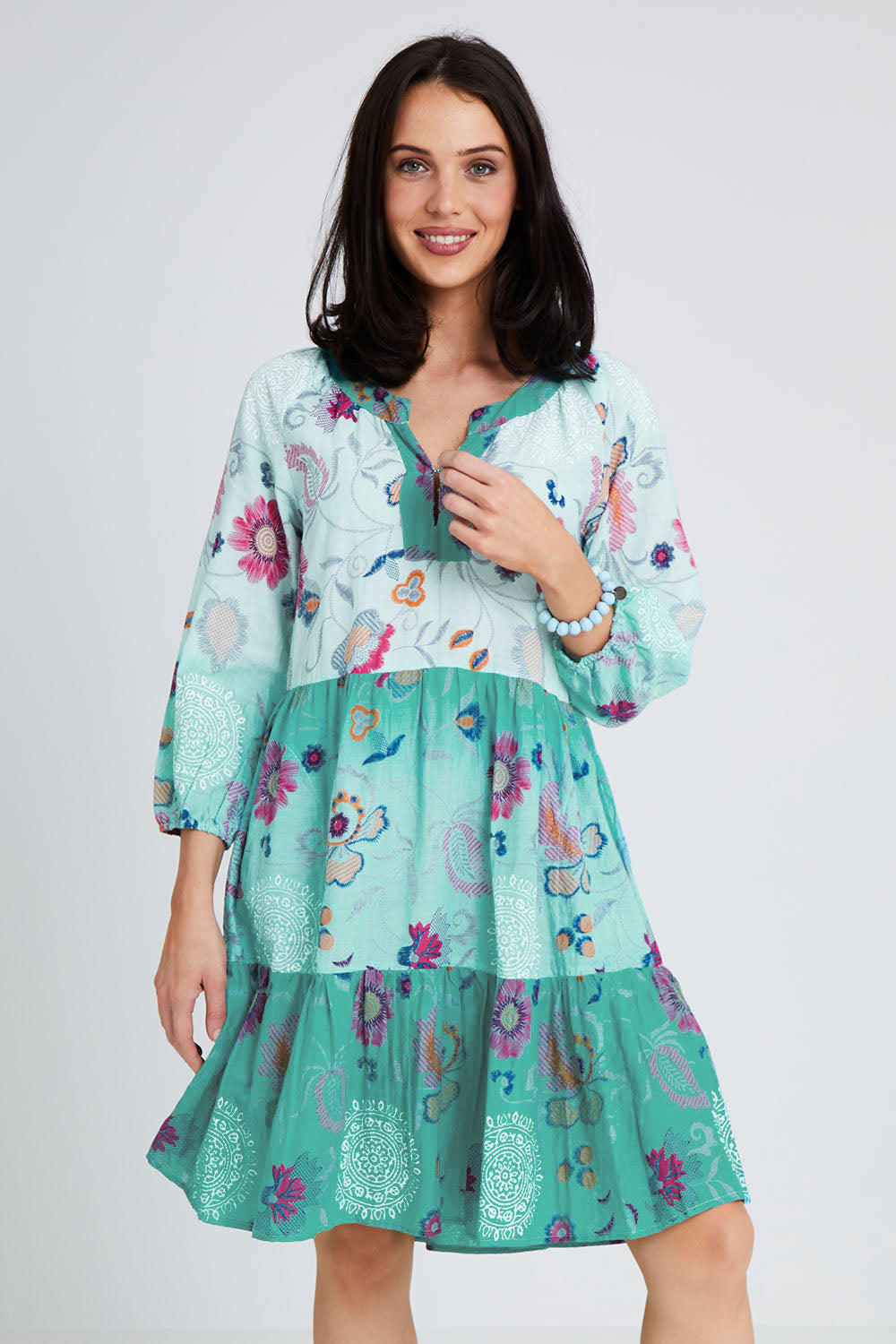 Model Andrea wearing size S of the Jerri Tiered Dress in colour Lagoon (Green), from the front, cropped image