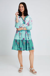 Model Andrea wearing size S of the Jerri Tiered Dress in colour Lagoon (Green), from the front, showing the whole outfit