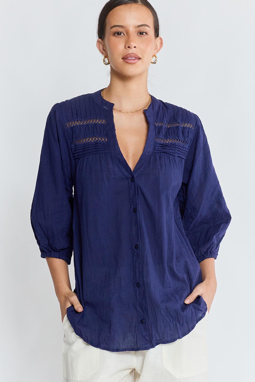 Model Genericm wearing size sample of the Laverne Tuck Shirt – Navy in colour Navy, in a cropped view