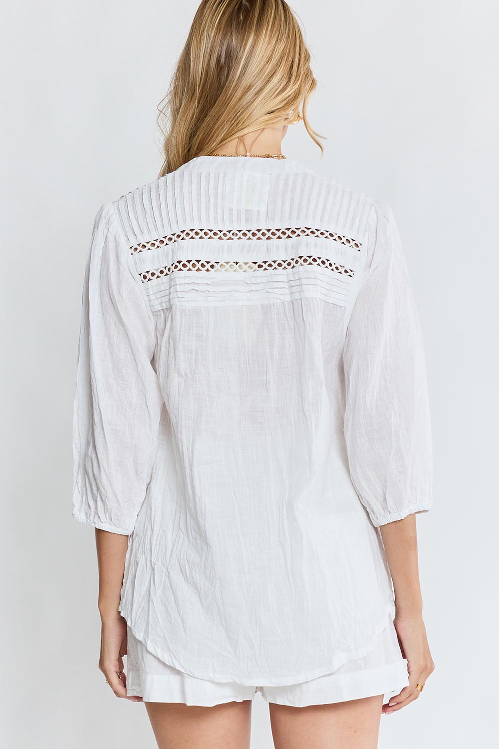Model Genericm wearing size sample of the Laverne Tuck Shirt – White in colour White, from the back