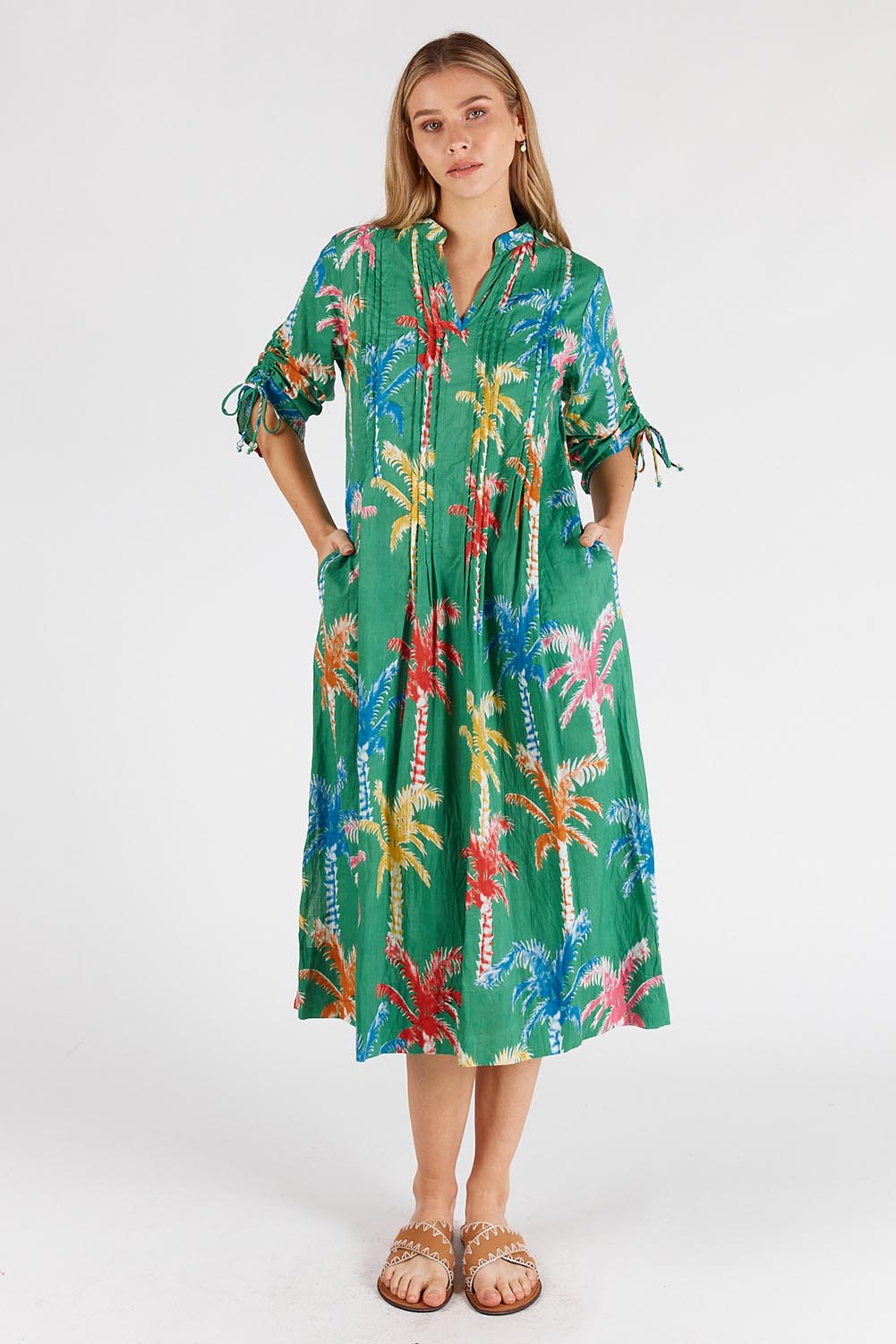 A model wearing the Leilani Cotton Midi Dress in colour Sea (Green), from the front, showing the whole outfit