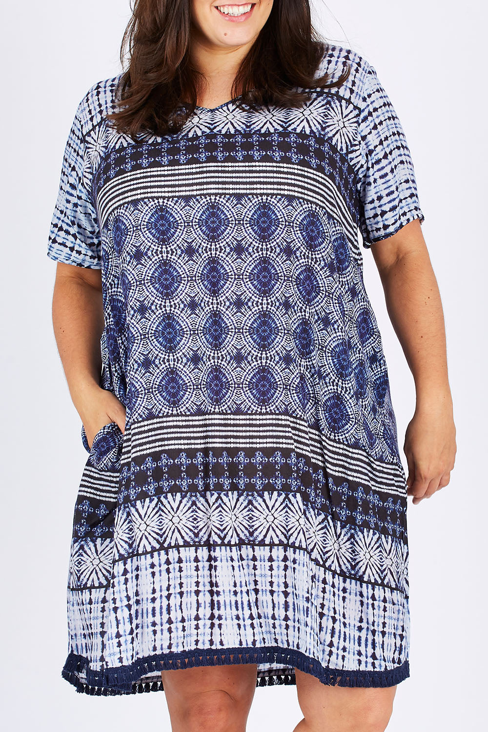 Model Mae wearing size XXL of the Lotus Dress in colour Navy (Blue), from the front, cropped image