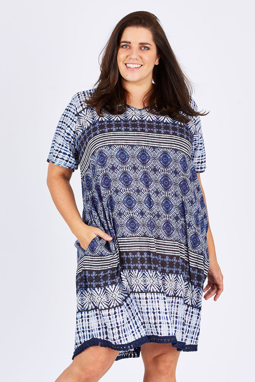 Model Mae wearing size XXL of the Lotus Dress in colour Navy (Blue), from the front, cropped image