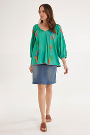 Model Madeline wearing size S of the Mermaid Top in colour Sea (Green), from the front, showing the whole outfit