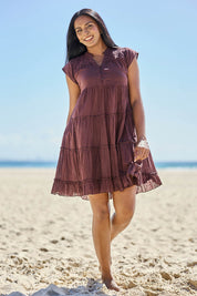 Model Eshan wearing size 10 of the Millie Tiered Dress - Espresso in colour Espresso, from the front