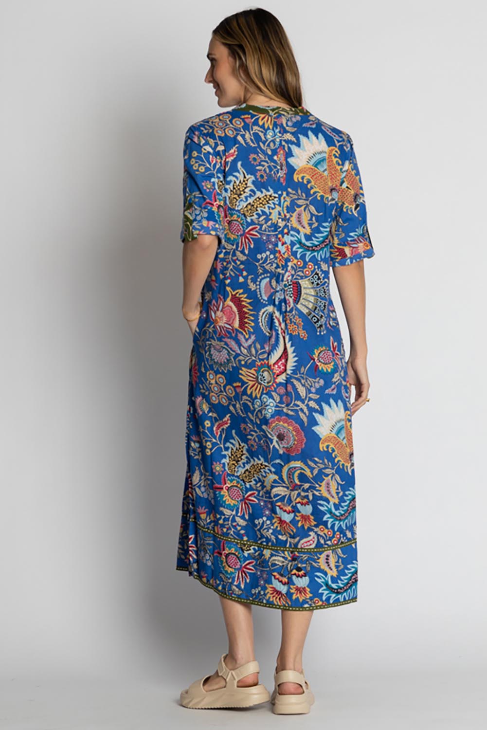 A model wearing the Nandita Cotton Midi Dress in colour Ocean (Blue), from the back