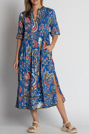 A model wearing the Nandita Cotton Midi Dress in colour Ocean (Blue), from the front, cropped image