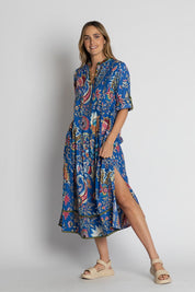A model wearing the Nandita Cotton Midi Dress in colour Ocean (Blue), from the front, showing the whole outfit