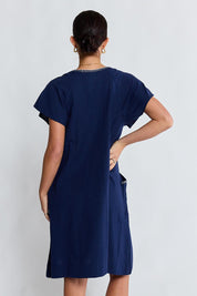 Model Genericm wearing size sample of the Remi Dress – Navy in colour Navy, from the back