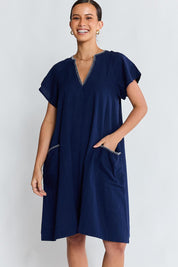 Model Genericm wearing size sample of the Remi Dress – Navy in colour Navy, in a cropped view