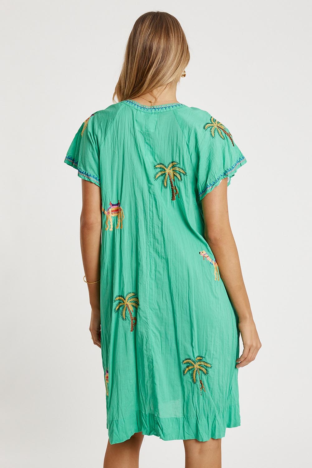 A model wearing the Sahara Cotton Dress in colour Sea (Green), from the back