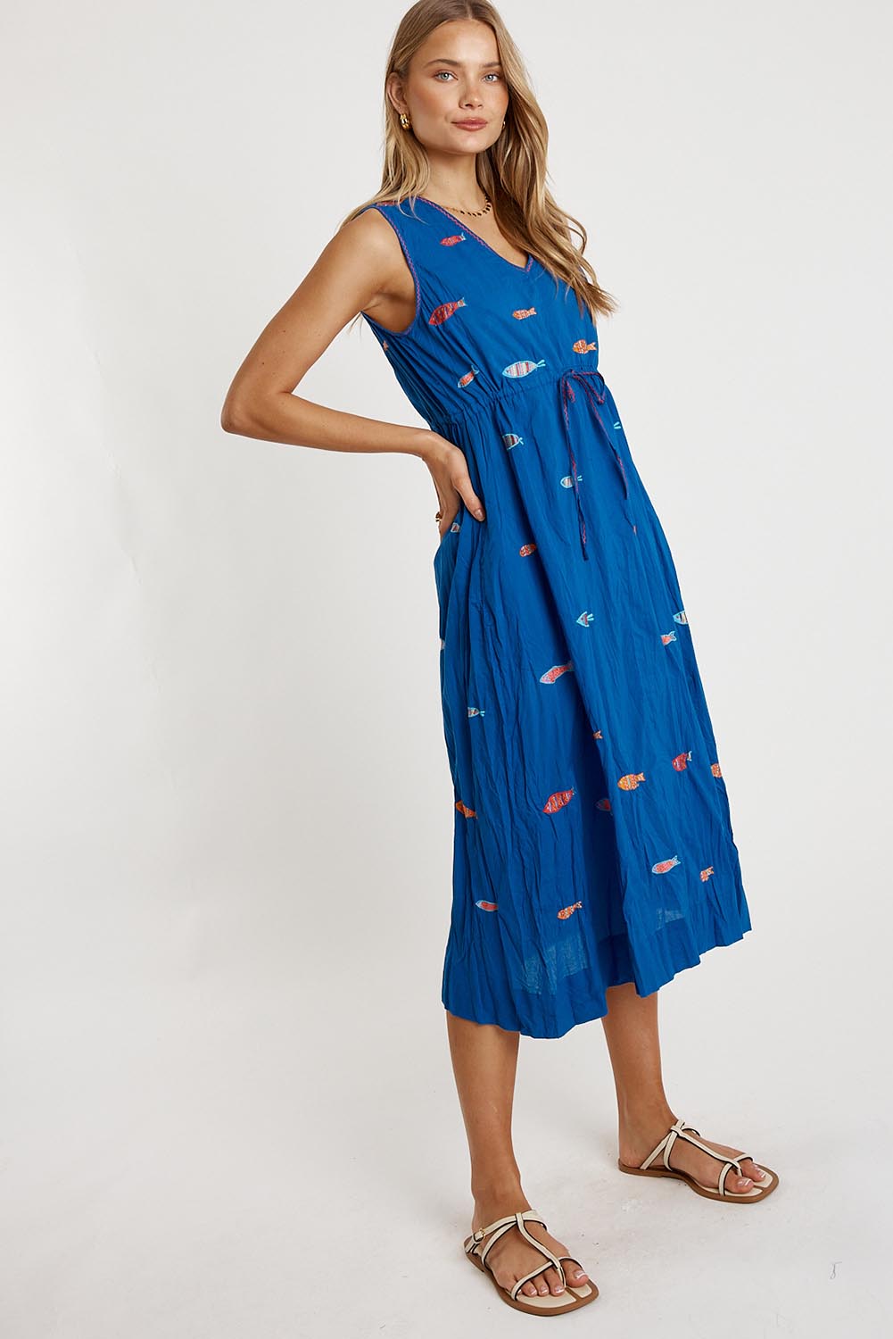 A model wearing the Sardine Tie Cotton Midi Dress in colour Ocean (Blue), from the front, showing the whole outfit