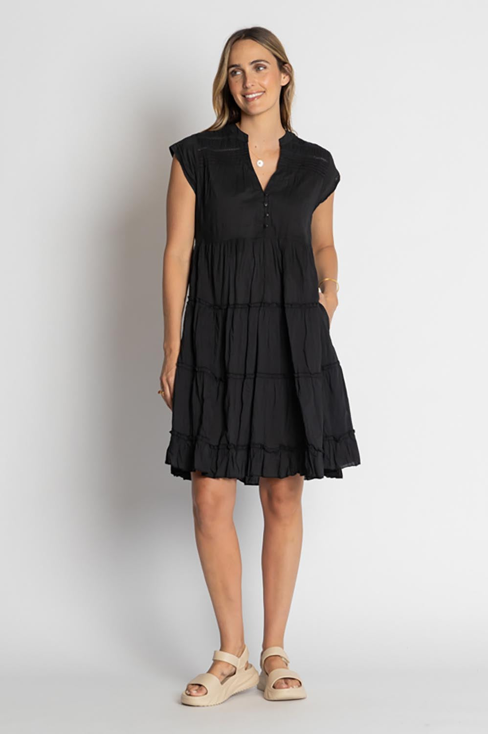 A model wearing the Shayna Cotton Tiered Dress in colour Black (Black), from the front, showing the whole outfit