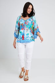 Model Andrea wearing size S of the Tara Top in colour Sky (Blue), from the front, showing the whole outfit