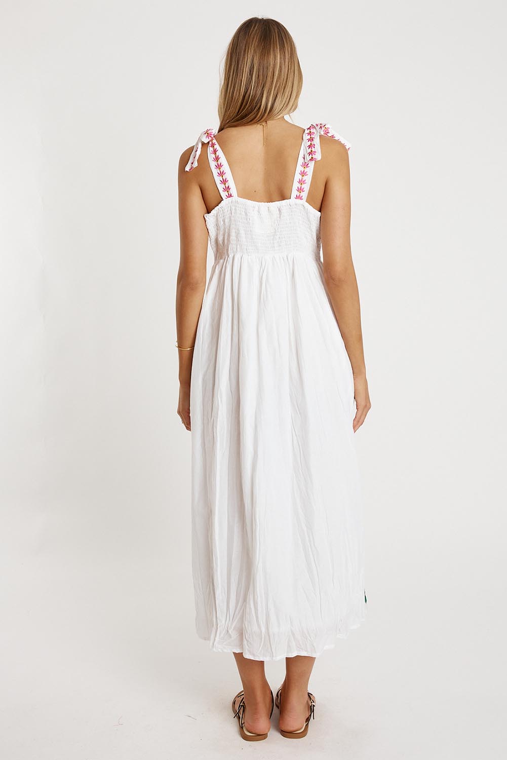 A model wearing the Tropicana Cotton Sundress in colour White (White), from the back