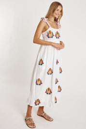 A model wearing the Tropicana Cotton Sundress in colour White (White), from the front, showing the whole outfit