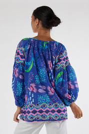 Model Genericm wearing size sample of the Yasmin Top – Ocean in colour Ocean, from the back