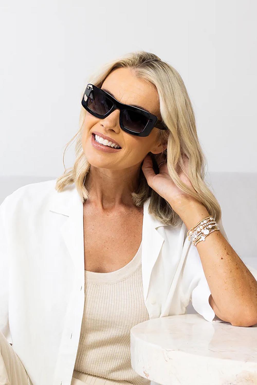 A model wearing the Bailey Sunglasses in colour Black (Black), from the front, cropped image