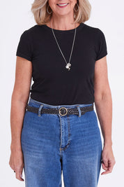 Model Sandy wearing size S of the Catrina Woven Leather Belt in colour Black (Black), from the front, cropped image