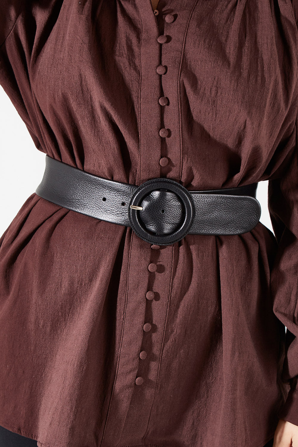Model Charlotte wearing size S of the Skye Wide Leather Waist Belt in colour Black (Black), from the front, cropped image