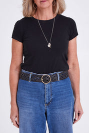 Model Sandy wearing size S of the Alice Leather Belt in colour Black (Black), from the front, cropped image