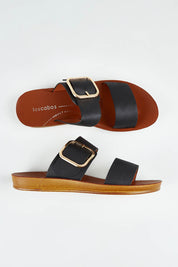 A model wearing size 37 of the Doti Double Strap Slide in colour Black (Black), from the front, showing the whole outfit