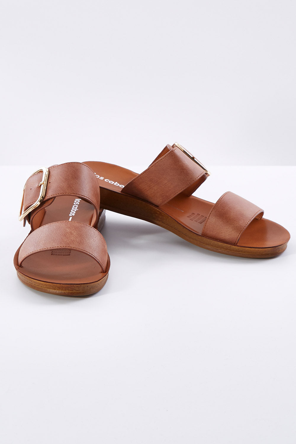 A model wearing size 38 of the Doti Double Strap Slide in colour Chocolate, from the front, showing the whole outfit
