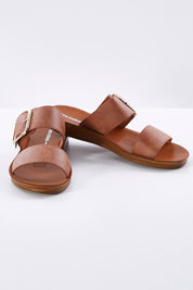 A model wearing size 38 of the Doti Double Strap Slide in colour Chocolate, from the front, showing the whole outfit
