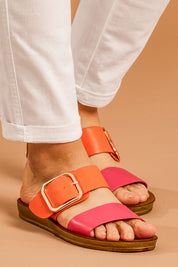 A model wearing size 38 of the Doti Double Strap Slide in colour Pinkorange (Pink), from the front, cropped image