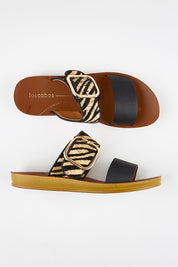 Model Genericm wearing size sample of the Doti Double Strap Slide - Zebra in colour Zebra, in a cropped view