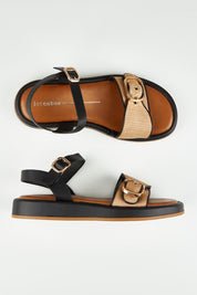 A model wearing size 37 of the Granada Sandal in colour Caramel, from the front, showing the whole outfit
