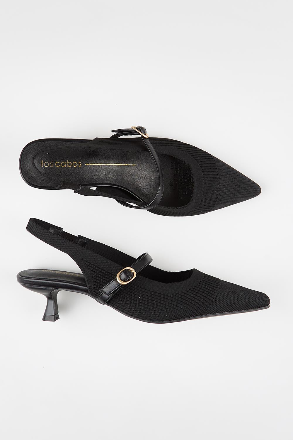 Model Genericm wearing size sample of the Kiti Heel - Black in colour Black, from an angle