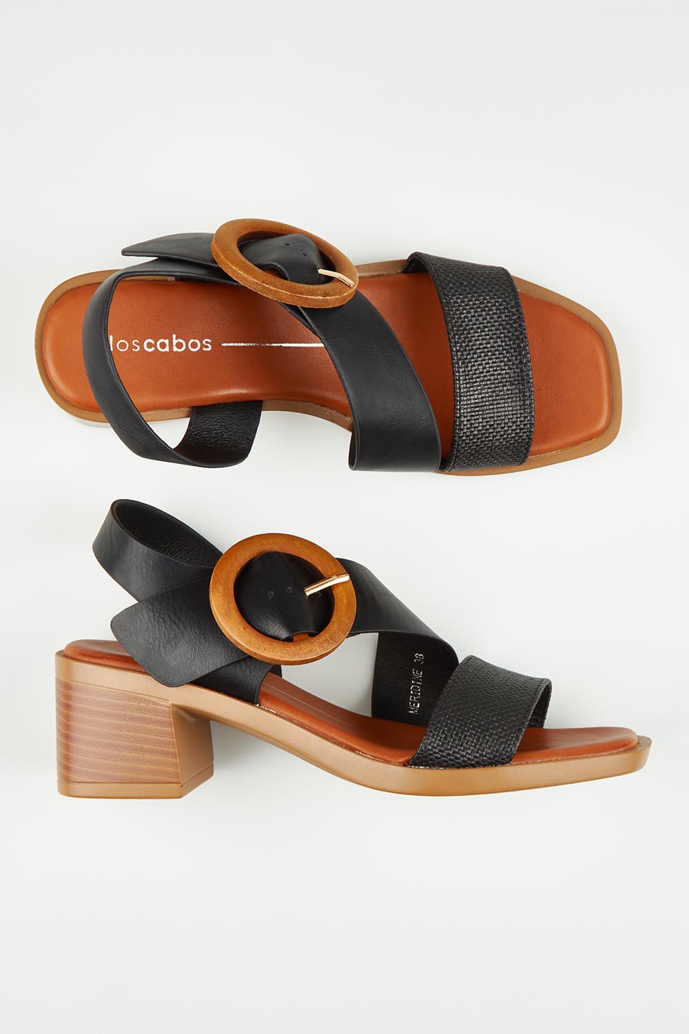 A model wearing size 37 of the Meridine Heel in colour Black (Black), from the front, showing the whole outfit