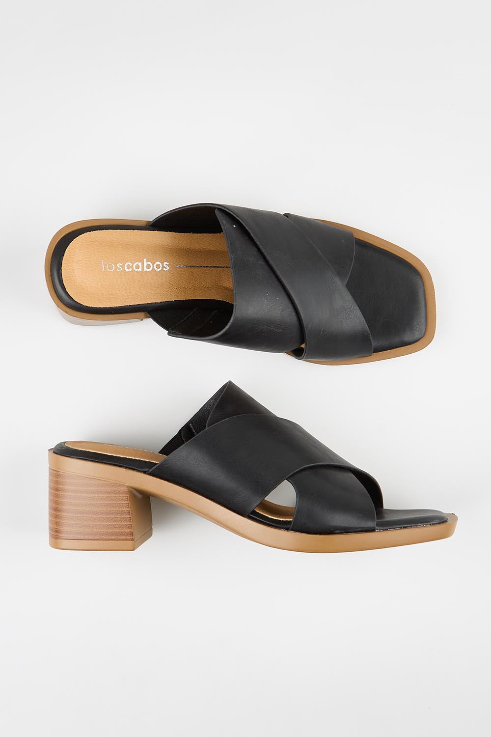 Model Genericm wearing size sample of the Meri Heel - Black in colour Black, from an angle