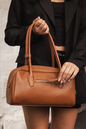 A model wearing the Paloma Shoulder Bag in colour Tan, from the front, showing the whole outfit