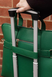 A model wearing the Rhodes Laptop Bag in colour Green (Green), from the front, showing the whole outfit