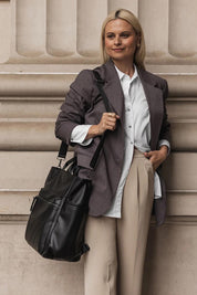 A model wearing the Bronx Backpack in colour Black (Black), from the front, showing the whole outfit