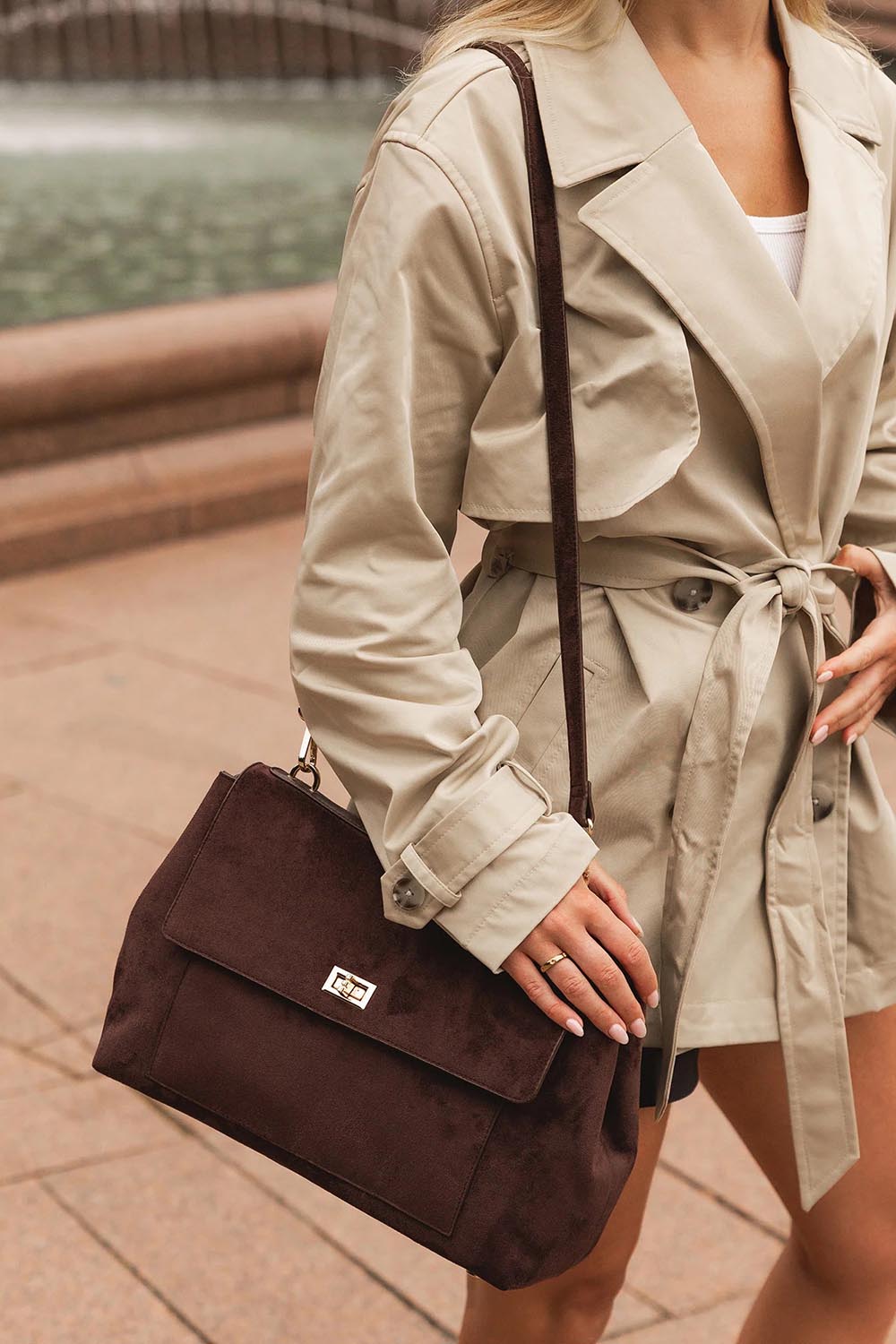 A model wearing the Arden Suedette Shoulder Bag in colour Chocolate, from the front, showing the whole outfit
