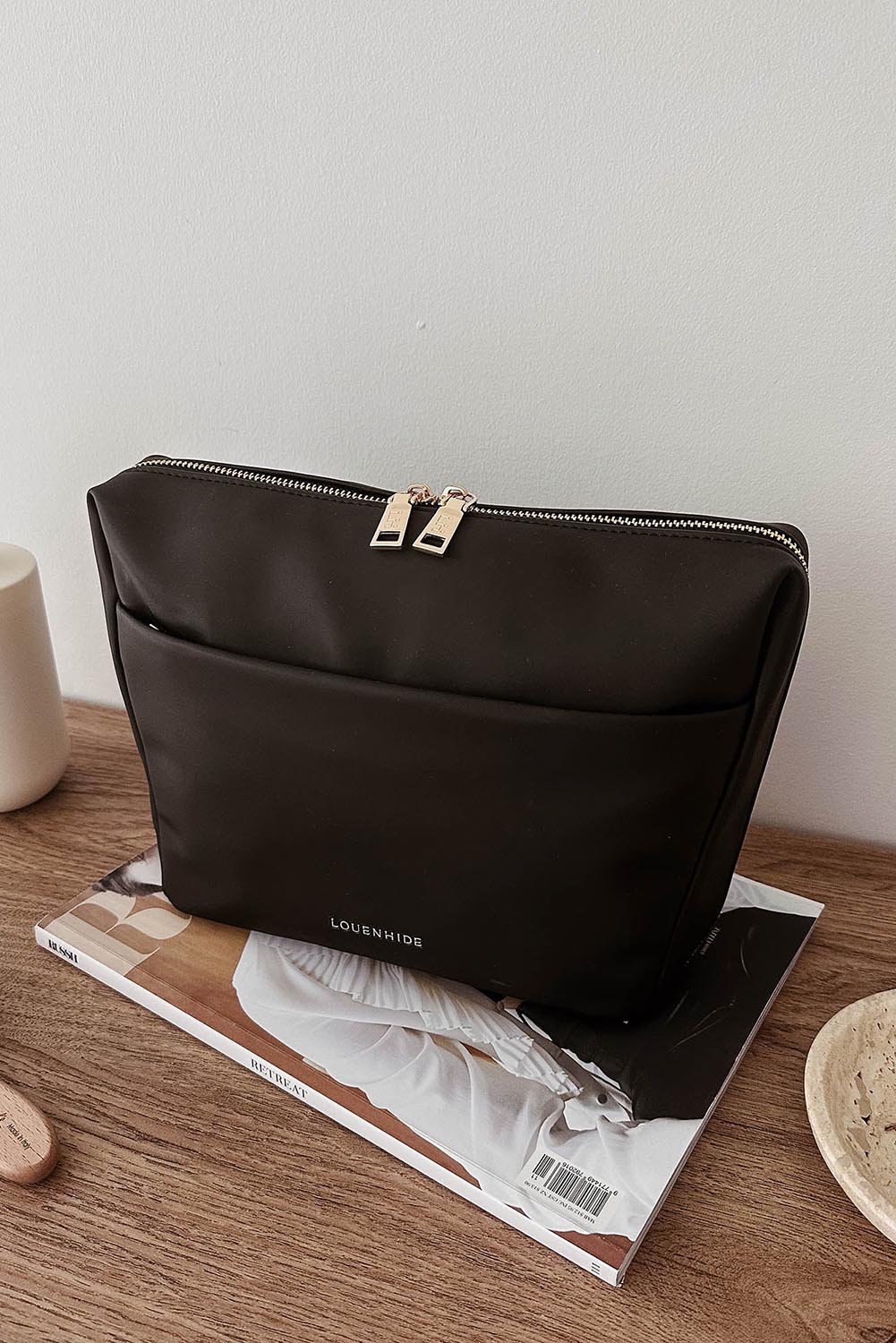 A model wearing the Vanessa Cosmetic Case in colour Black (Black), from the front, showing the whole outfit