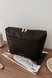 A model wearing the Vanessa Cosmetic Case in colour Black (Black), from the front, showing the whole outfit