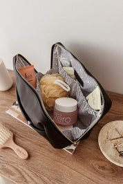 A model wearing the Vanessa Cosmetic Case in colour Black (Black), from the front, showing the whole outfit