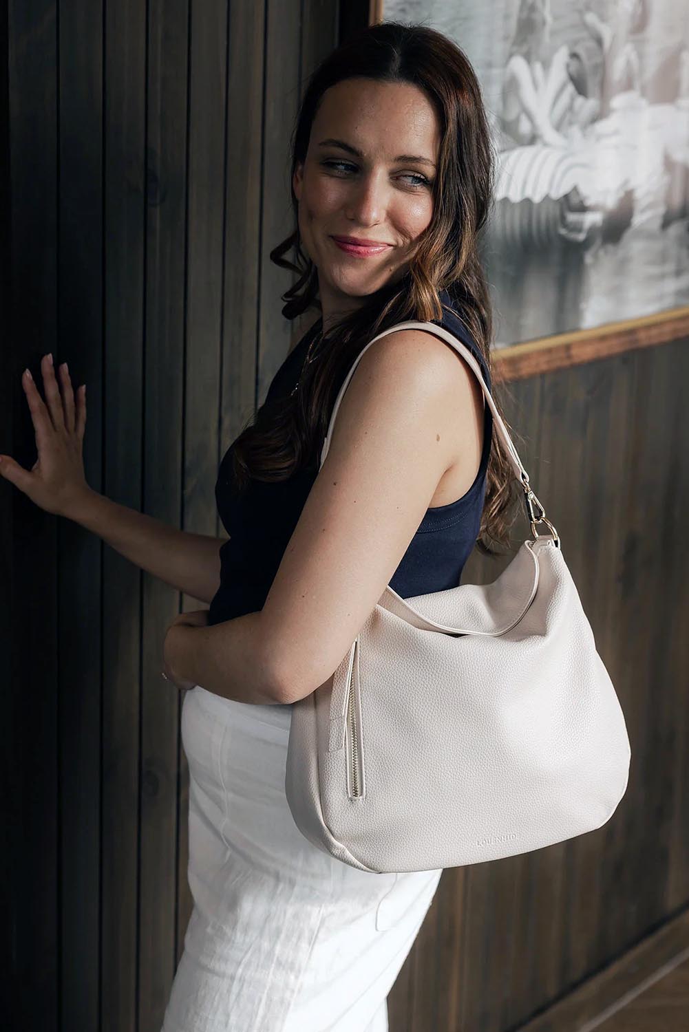 A model wearing the Nadia Shoulder Bag in colour Vanilla, from the front, showing the whole outfit
