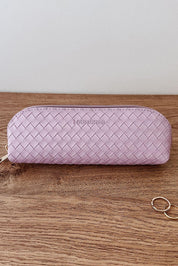 A model wearing the Jayne Makeup Bag in colour Lilac (Purple), from the front, showing the whole outfit