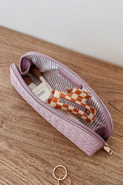 A model wearing the Jayne Makeup Bag in colour Lilac (Purple), from the front, showing the whole outfit